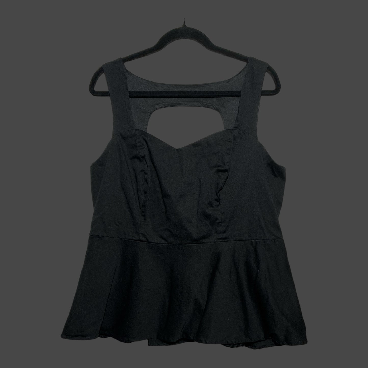 But I Wish It Was Black sleeveless black peplum top with sweetheart neckline and back cutout detail on a hanger