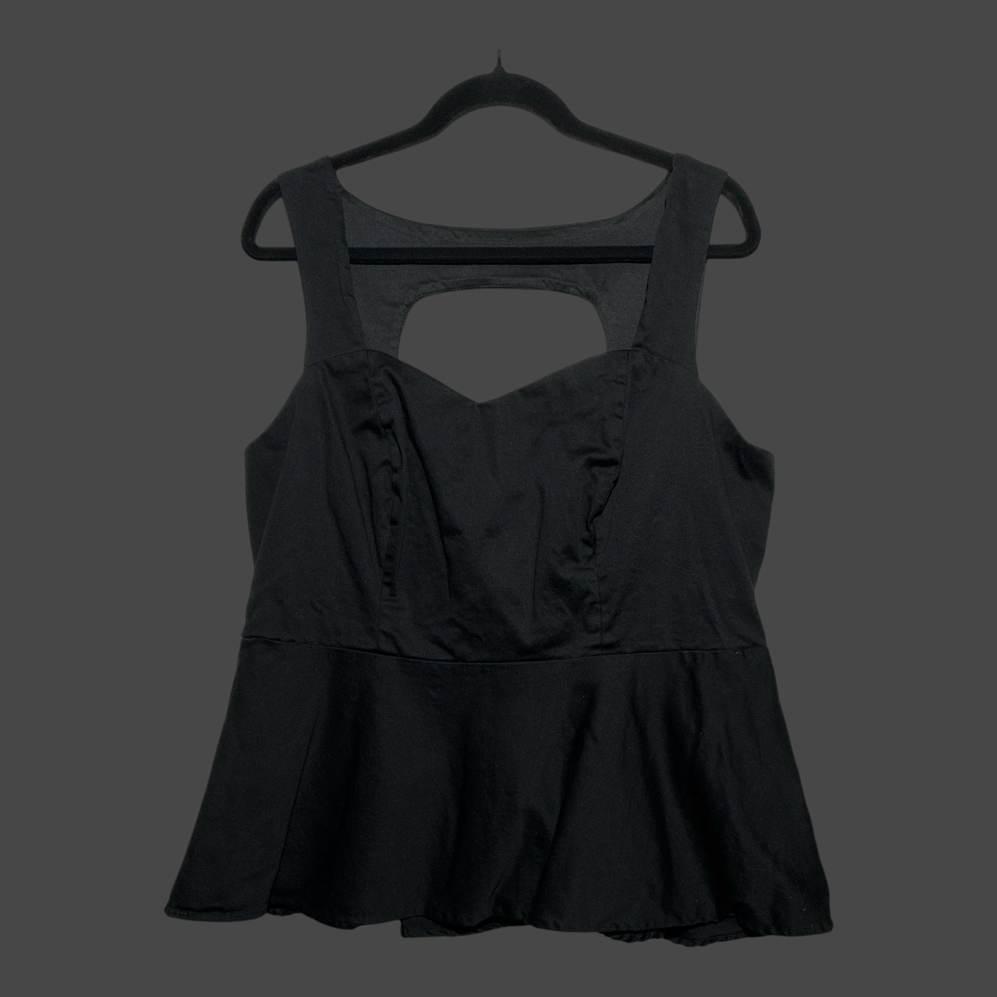 But I Wish It Was Black sleeveless black peplum top with sweetheart neckline and back cutout detail on a hanger