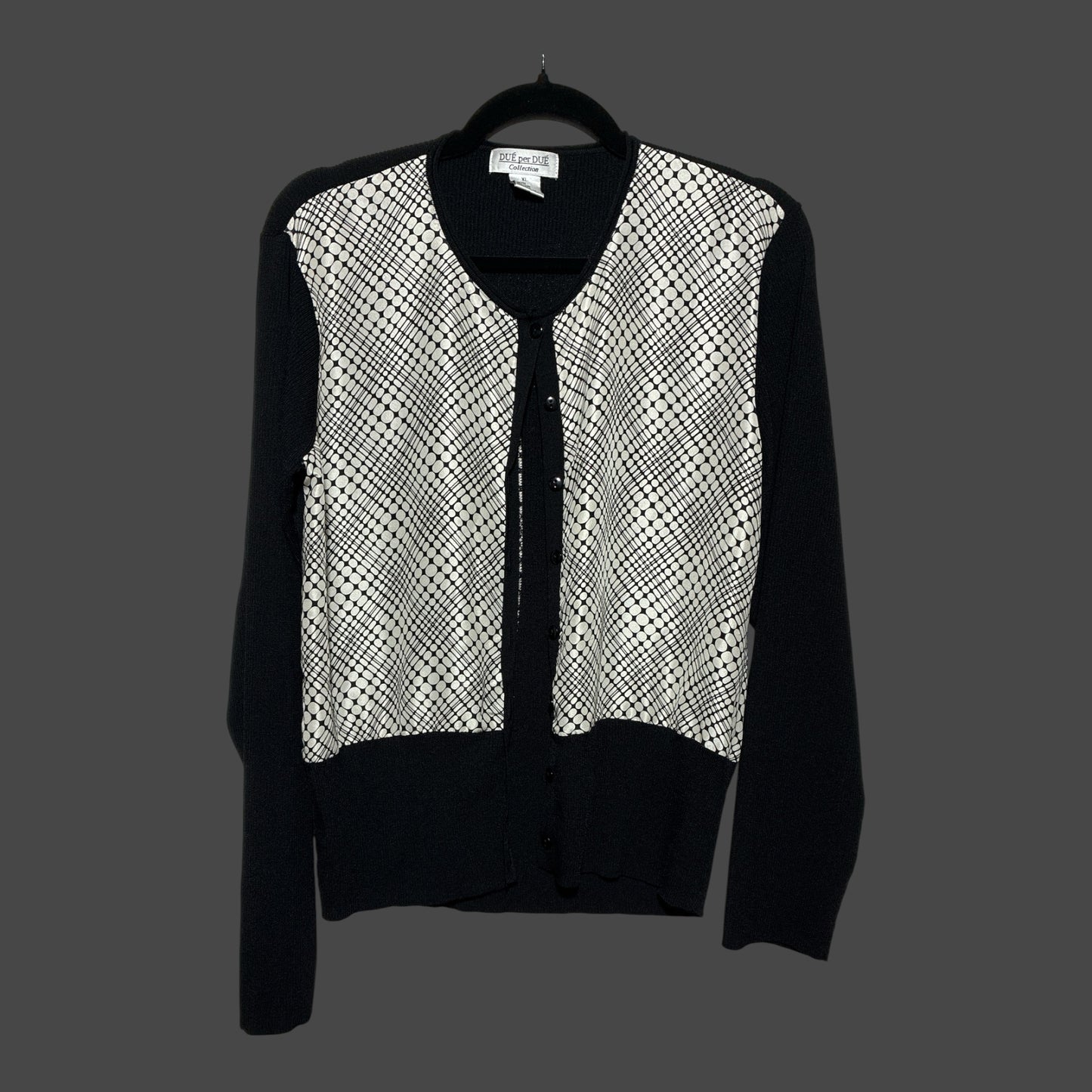 But I Wish It Was Black knit cardigan with black sleeves and a white and black geometric dot pattern front panel